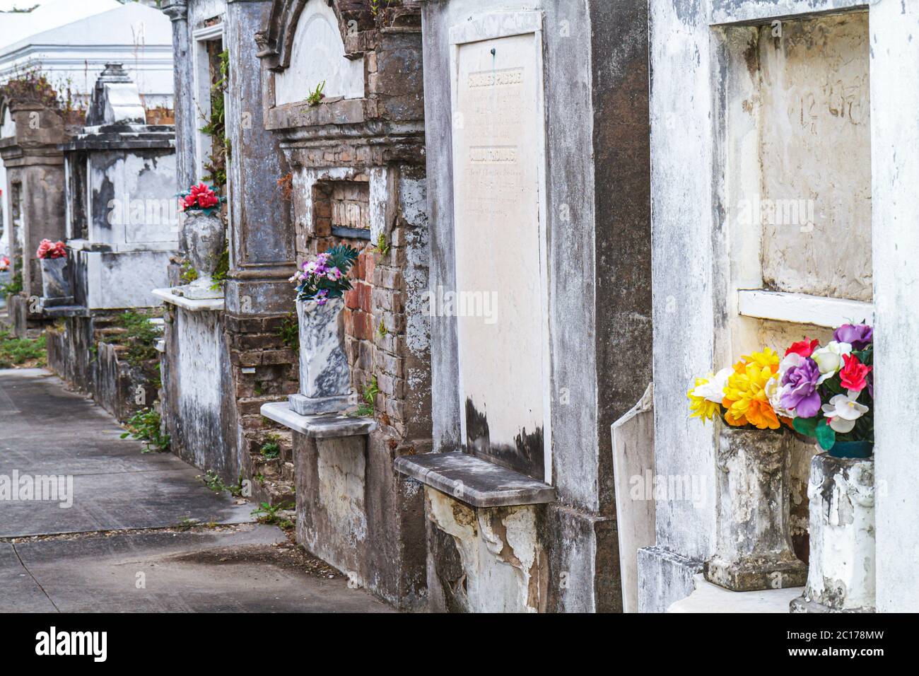 New Orleans Louisiana,Garden District,historic Lafayette Cemetery Number 1mausoleum,death,burial site,graveyard,tomb,flower,deteriorated,fading inscri Stock Photo