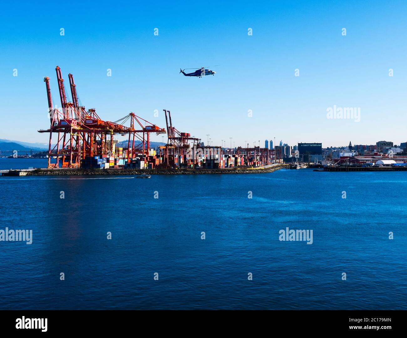 Helicopter flying over Vancouver docks. Stock Photo