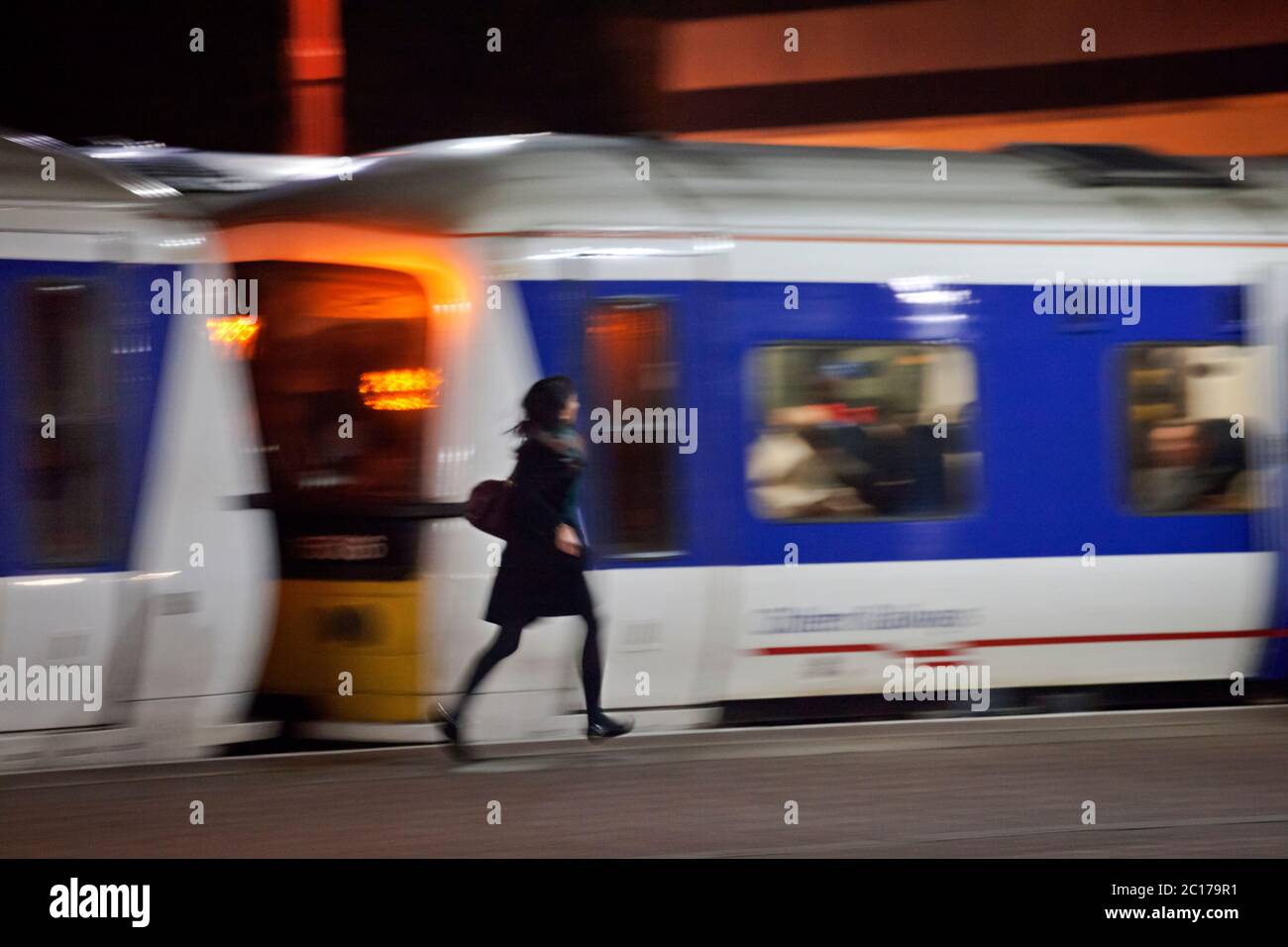 Rail commuter running for the rush hour train just before departure at