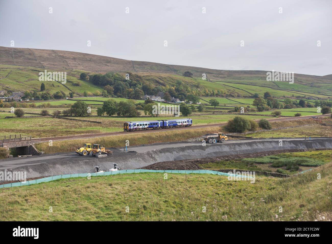 Northern Rail class 158 sprinter train passing the construction of the freight siding for Arcow Quarry at Helwith Bridge, Yorkshire, UK Stock Photo