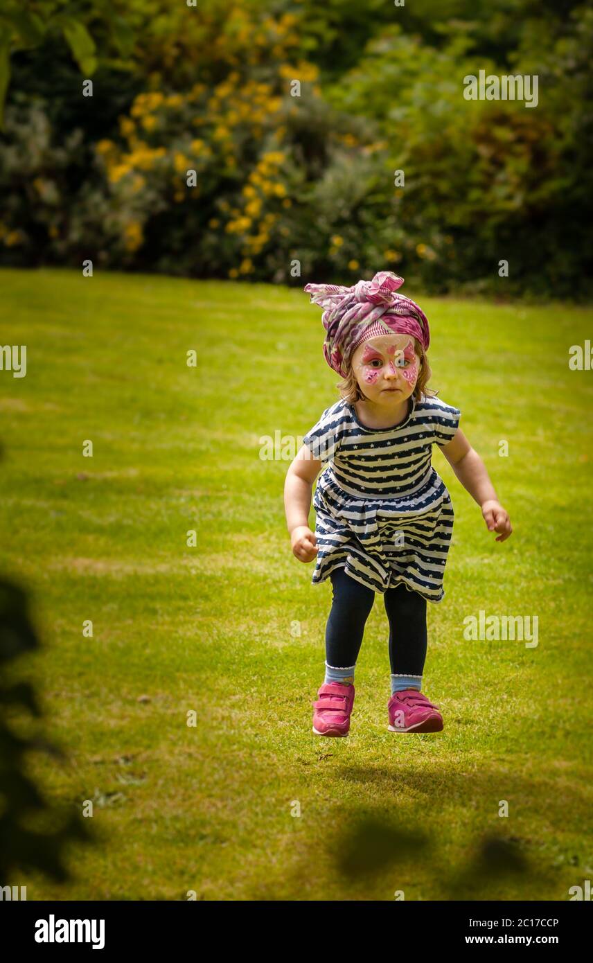 Cute little girl jumping high Stock Photo - Alamy