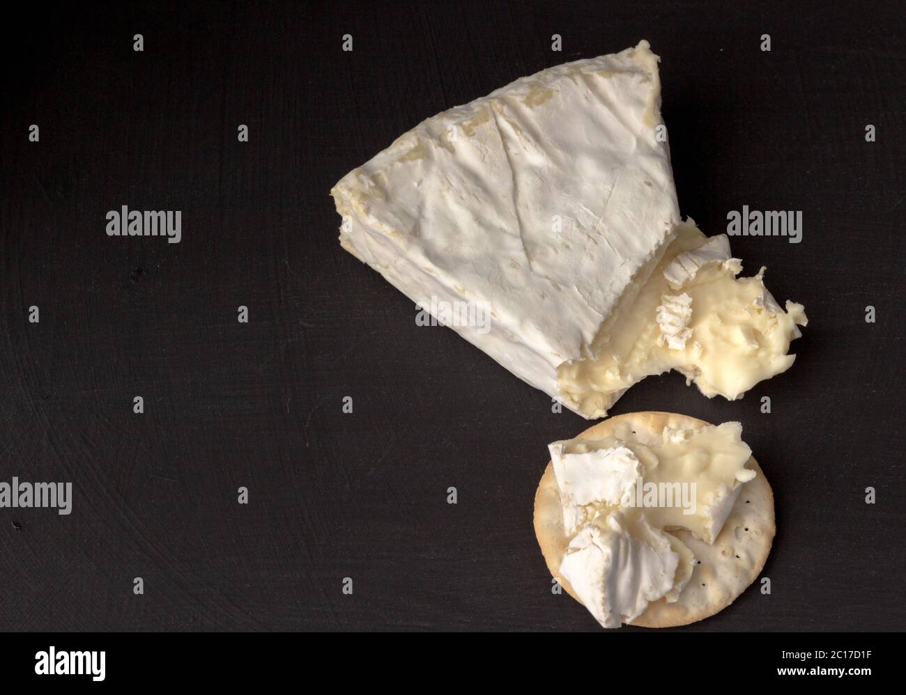 Brie type of cheese. Camembert cheese. Fresh Brie cheese wedge cut and