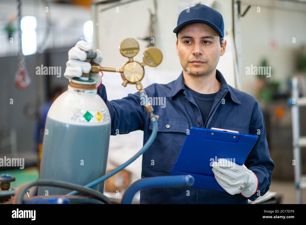 Inspector checking a gas tank in an industrial factory Stock Photo Alamy