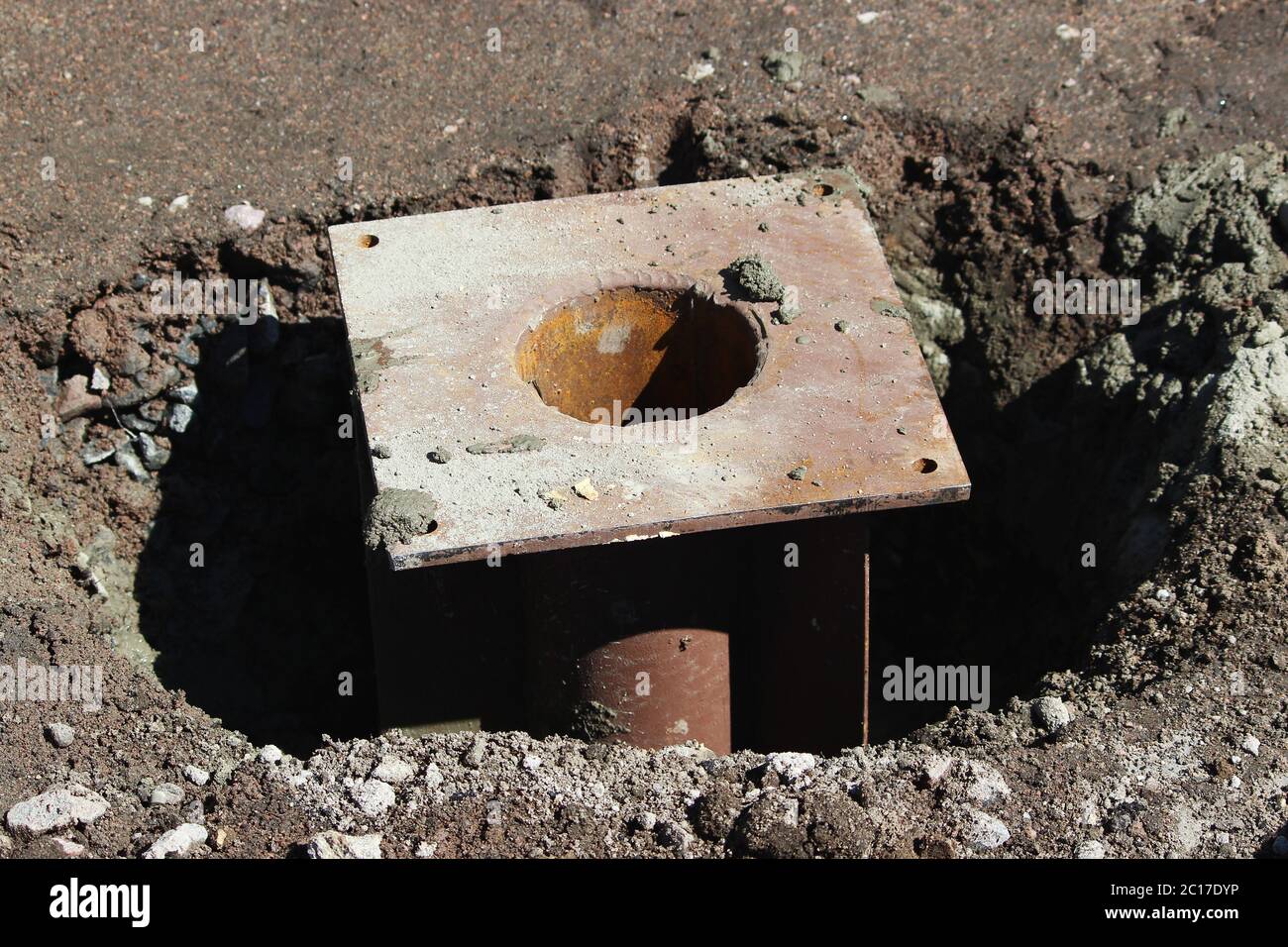 Metal element of the foundation of the support for fixing the traffic light near the road Stock Photo