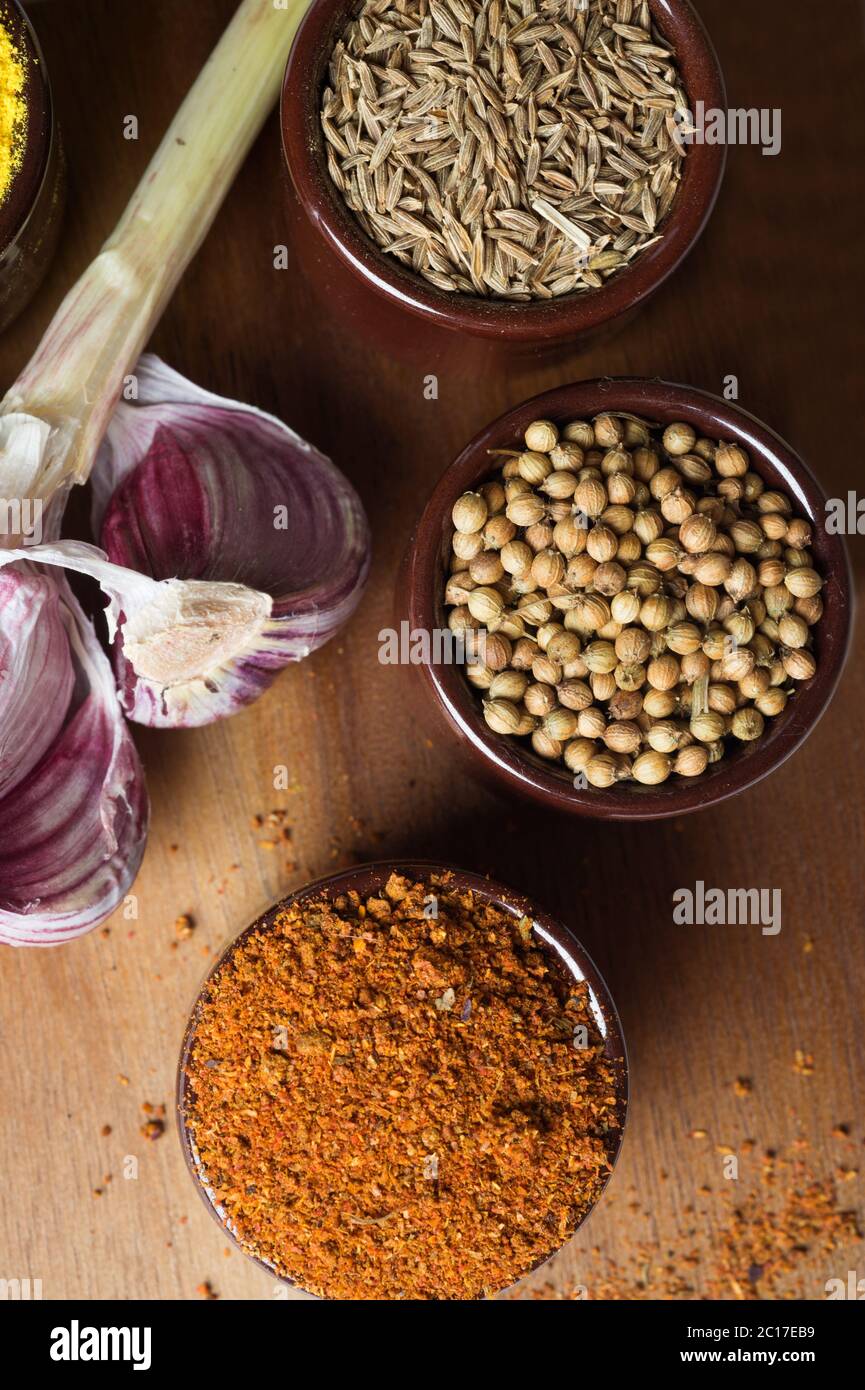 Spices and herbs in ceramic bowls. Food and cuisine ingredients. Colorful natural additives. Stock Photo