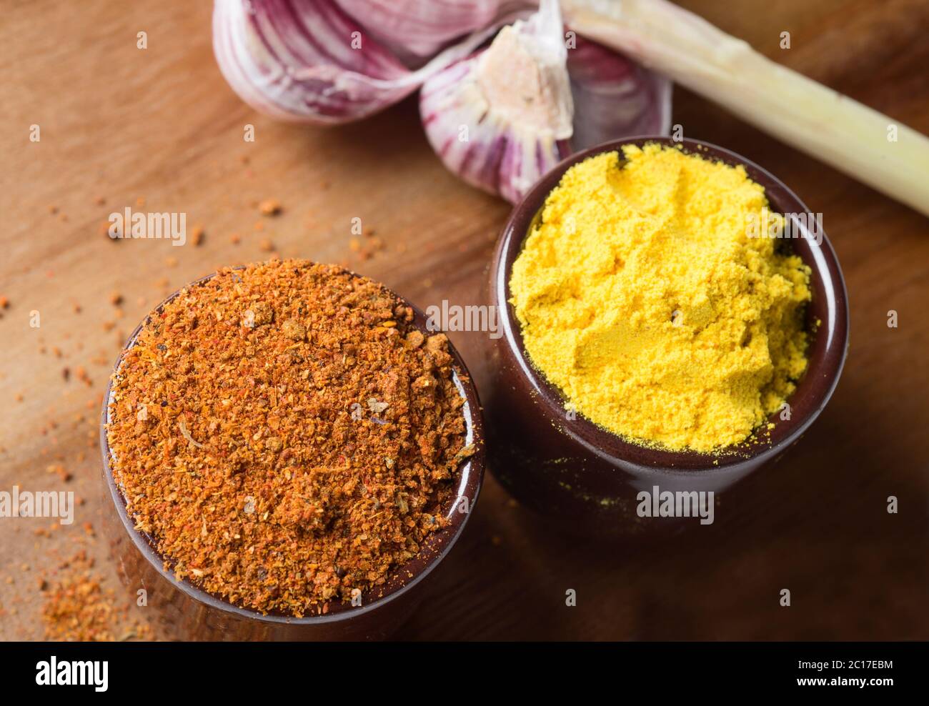 Spices and herbs in ceramic bowls. Food and cuisine ingredients. Colorful natural additives. Stock Photo