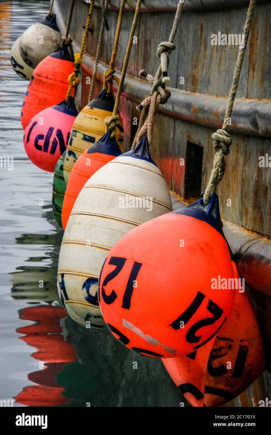 Colorful buoys hanging on a fishing boat, Seward harbor, Alaska Stock