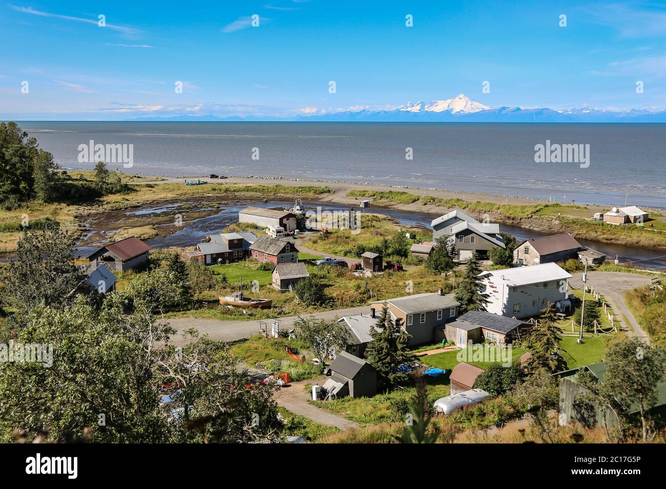 Aerial view of Ninilchik a small Alaskan Native village with Cook Inlet and Aleutian volcanoes in th Stock Photo