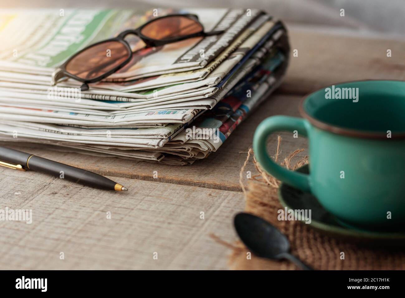 Newspapers and cups on wooden. Stock Photo