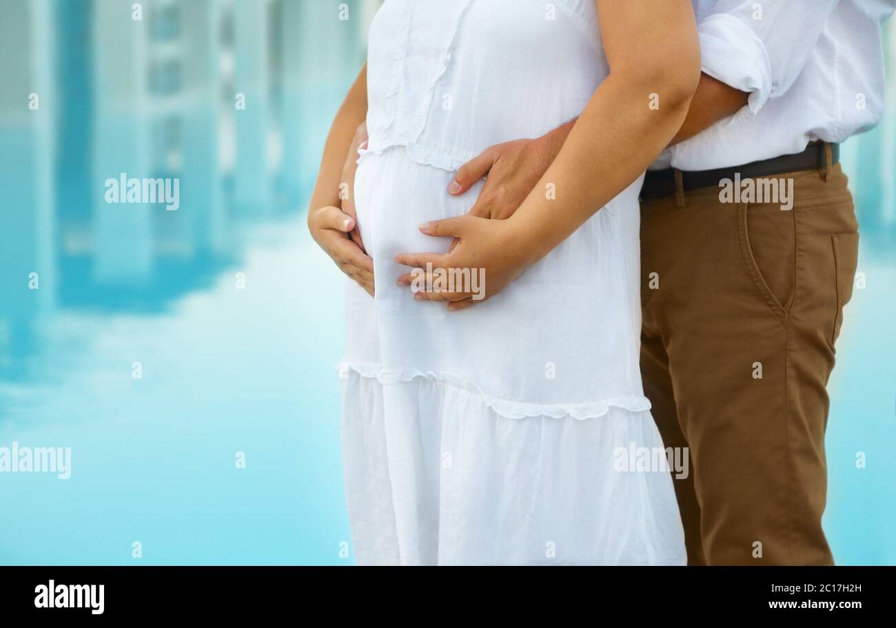 Man and young pregnant woman hugging outdoors Stock Photo - Alamy