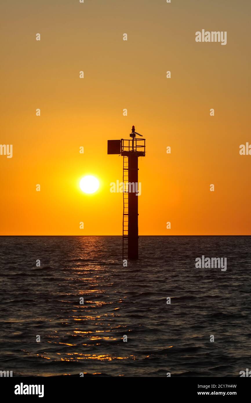 Sunset over the Sea of Carpentaria with a signal tower, Karumba, Queensland, Australia Stock Photo