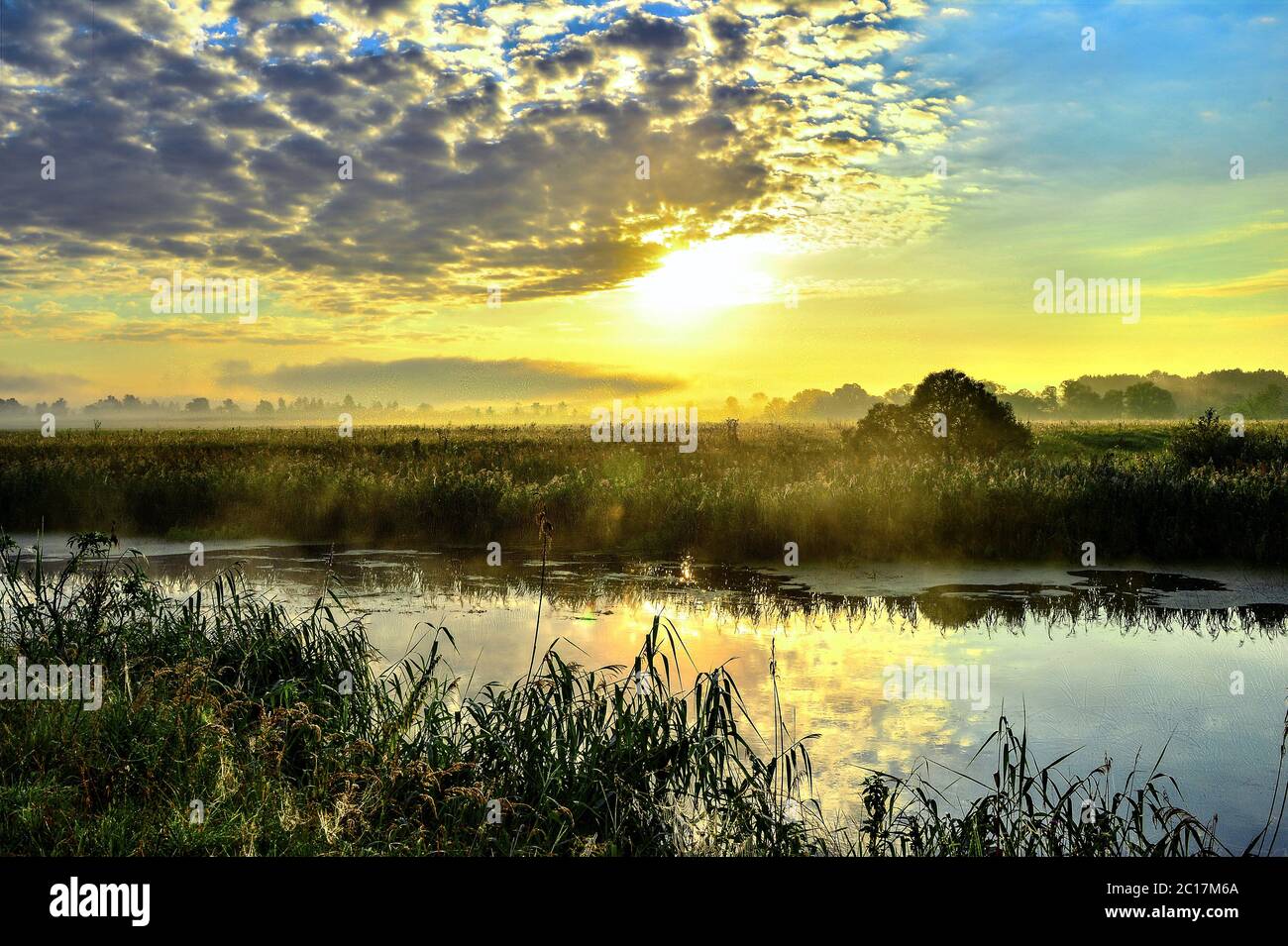 Photo with a sunny summer sunrise over the river Stock Photo - Alamy