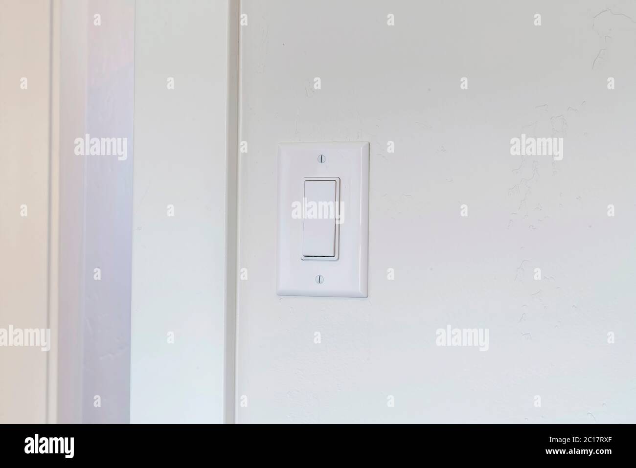 Indoor electrical light switch of home mounted on white wall background