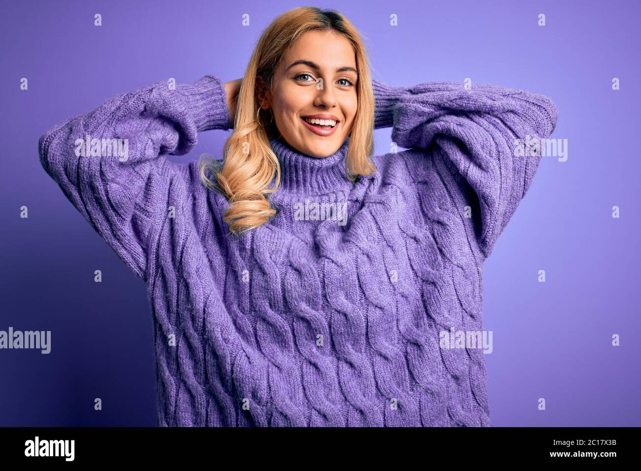 Young beautiful blonde woman wearing casual turtleneck sweater over ...