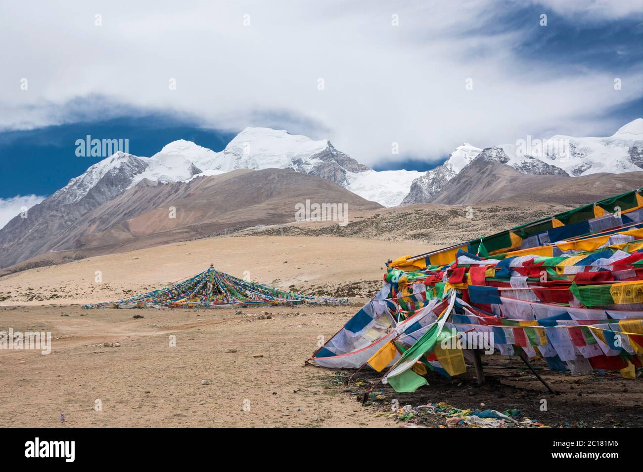 Prayer flags at the feet of the Nyenchen Tangula mountain Tibet Stock ...