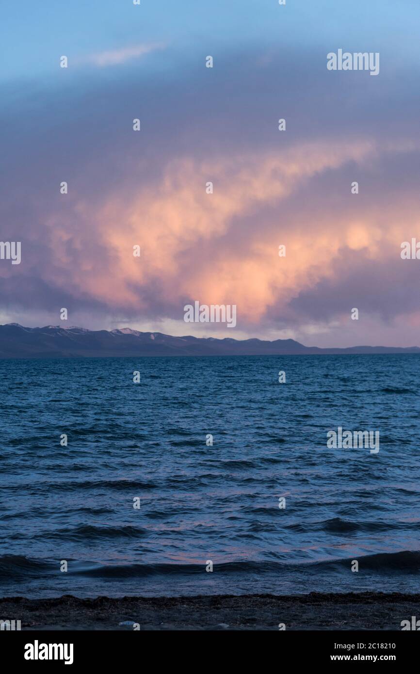 The Nyenchen Tangula mountain range seen across Nam lake at sunset ...