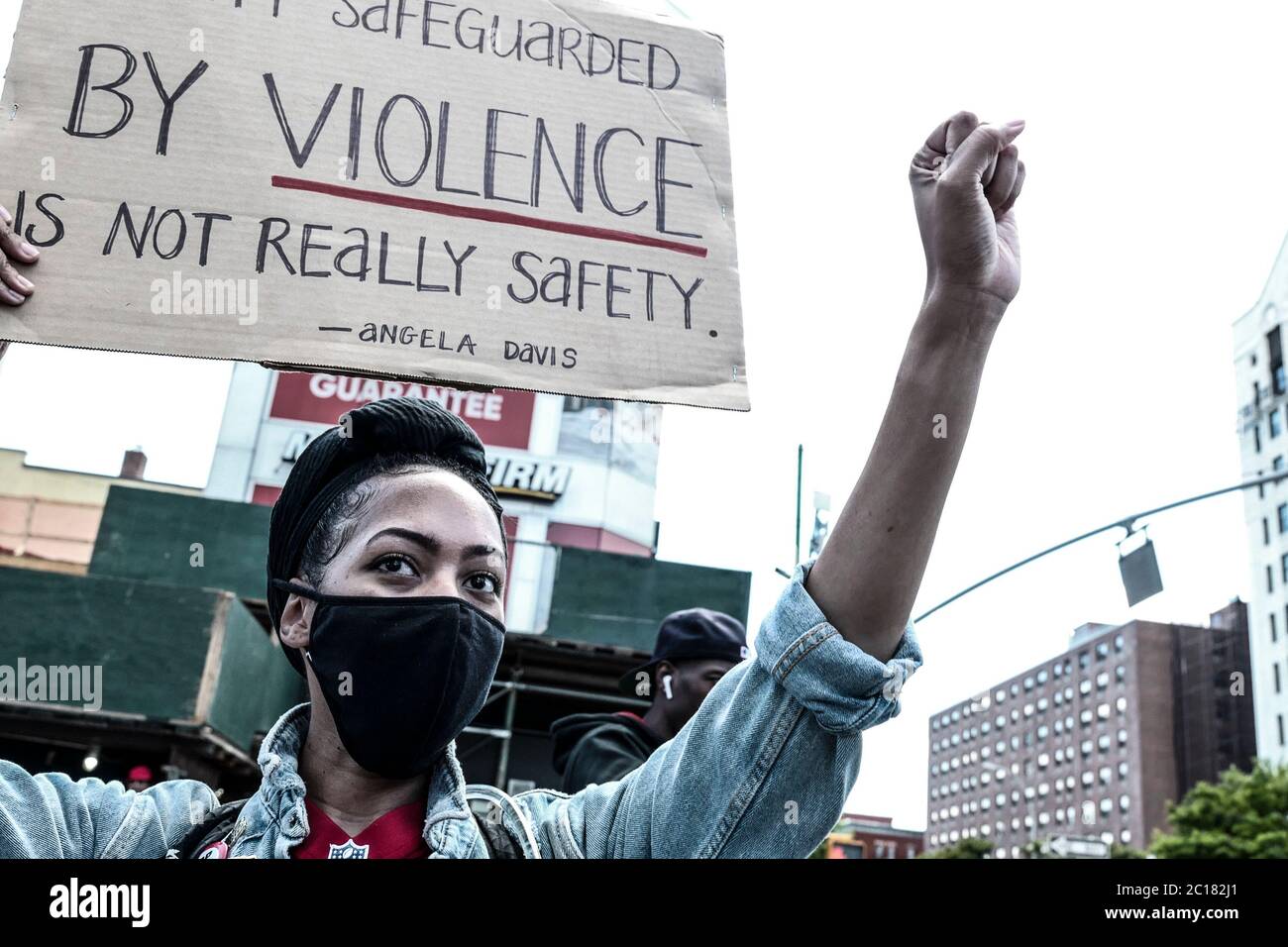 New York, New York, USA. 14th June, 2020. A woman holds a protest sign ...