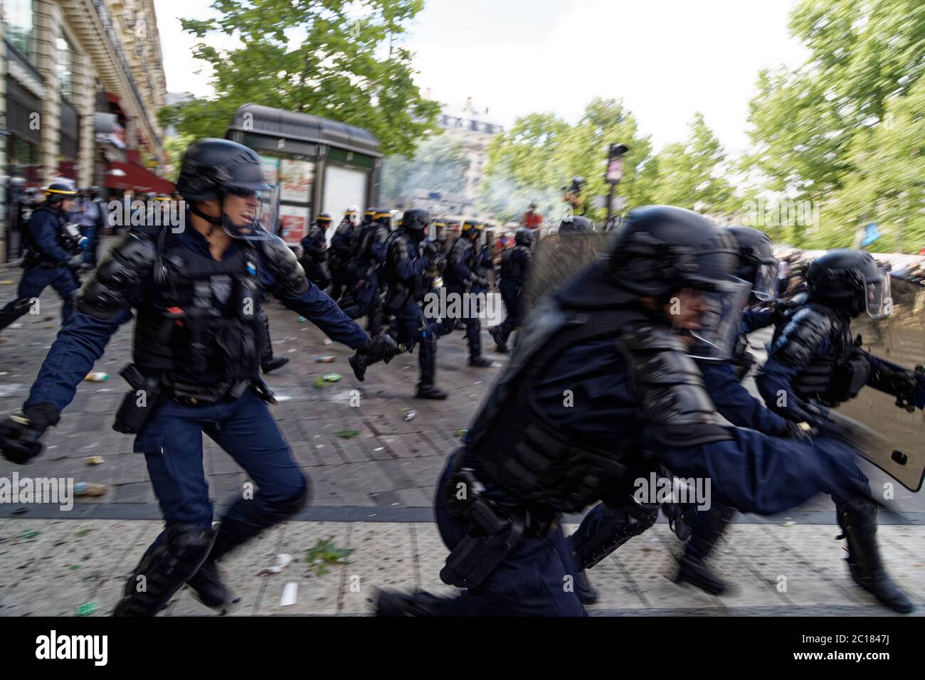 Paris, France. 13th June, 2020. Riot police charge protesters and use ...