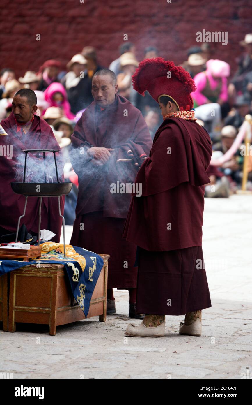 Monks making offerings through fire, Tsurphu monastery, Tibet Stock