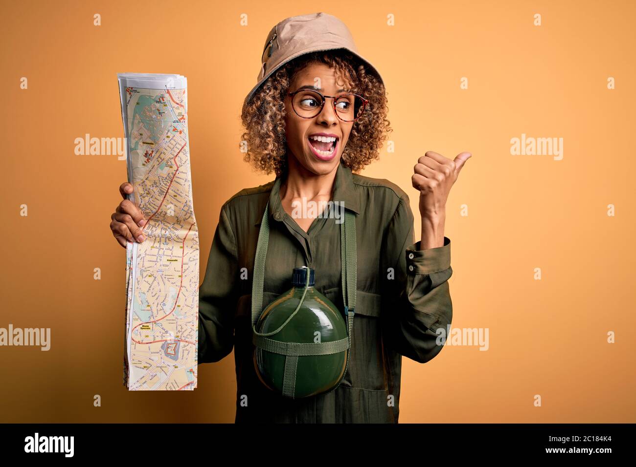 African american tourist woman wearing explorer hat and water canteen ...