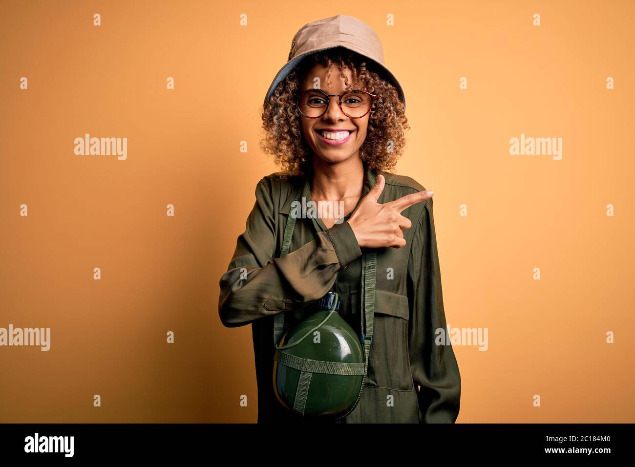 Young african american tourist woman on vacation wearing explorer hat ...