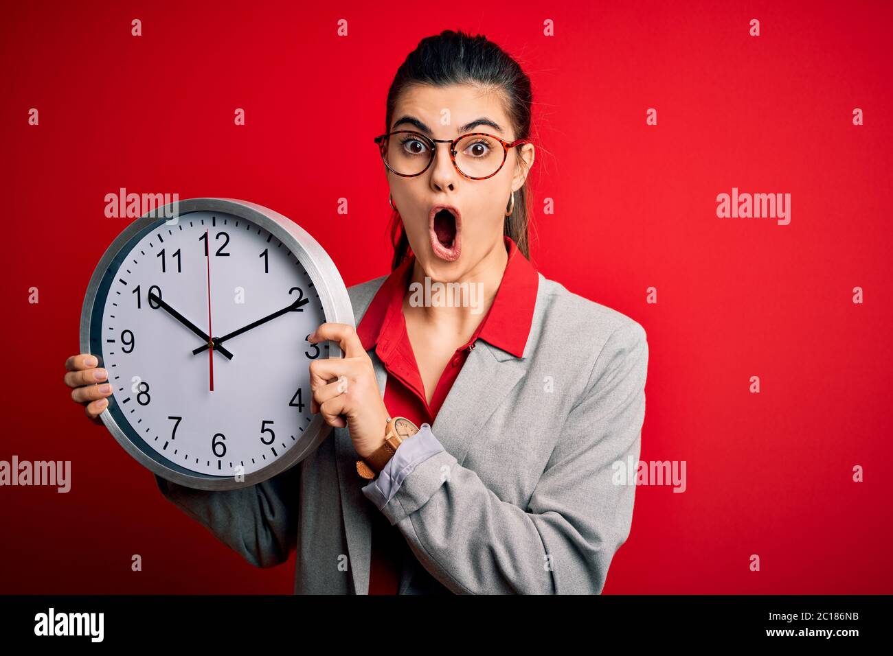 Young beautiful brunette businesswoman doing countdown holding big ...