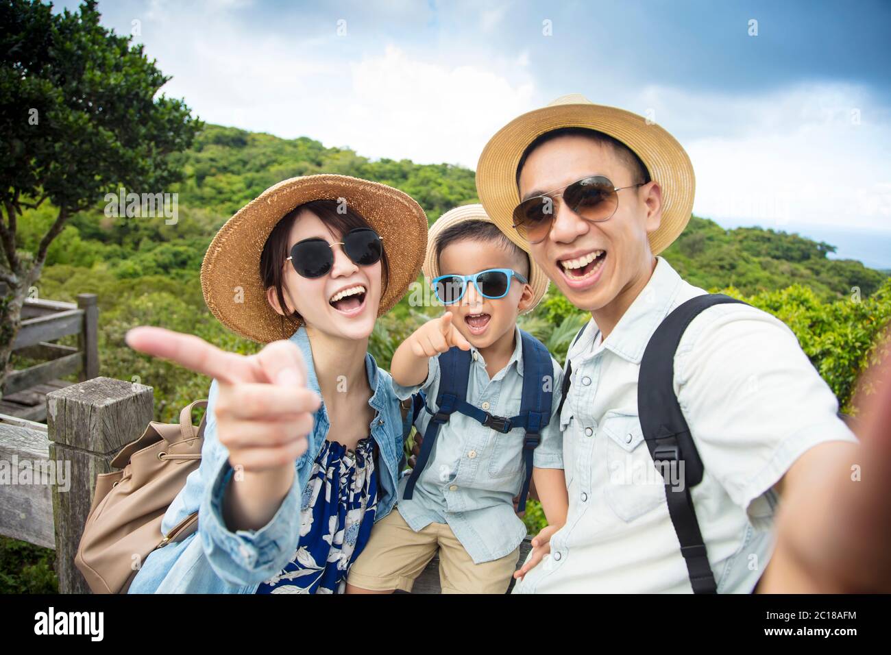 happy asian Family On Hiking Adventure and taking selfie Stock Photo