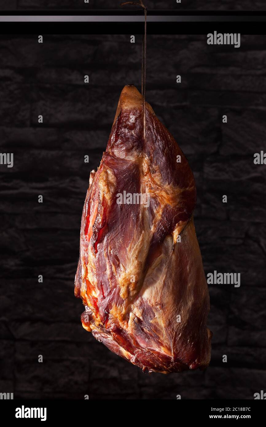 Smoked meat hanging on hook Stock Photo