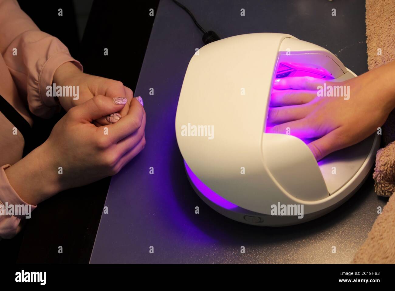 drying and fixing a transparent base base applied to the nails before