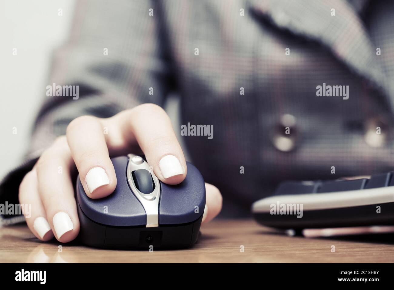 Woman using computer mouse and keyboard Stock Photo
