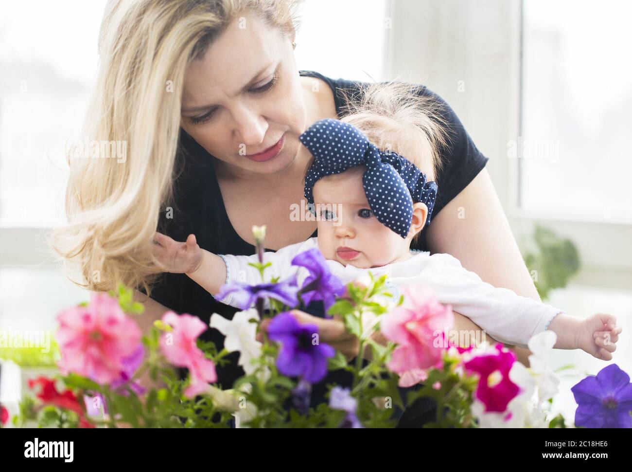 Mature woman embrace with baby girl Stock Photo Alamy