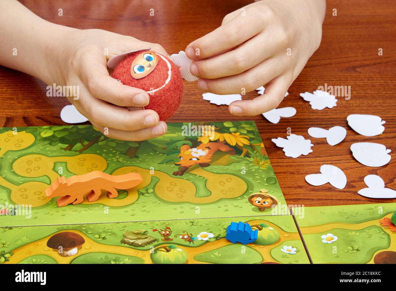 Hamburg, Germany. 14th June, 2020. A girl in the board game café 'Würfel & Zucker' in Eilbek holds a ball of the skill game 'Speedy Roll' (Piatnik publishing house), nominated for the 'Children's Game of the Year 2020'. Due to the Corona pandemic, an award ceremony was not held this year. The 'Children's Game of the Year' will be announced on 15.06.2020 via a live stream on Facebook. Credit: Georg Wendt/dpa/Alamy Live News Stock Photo