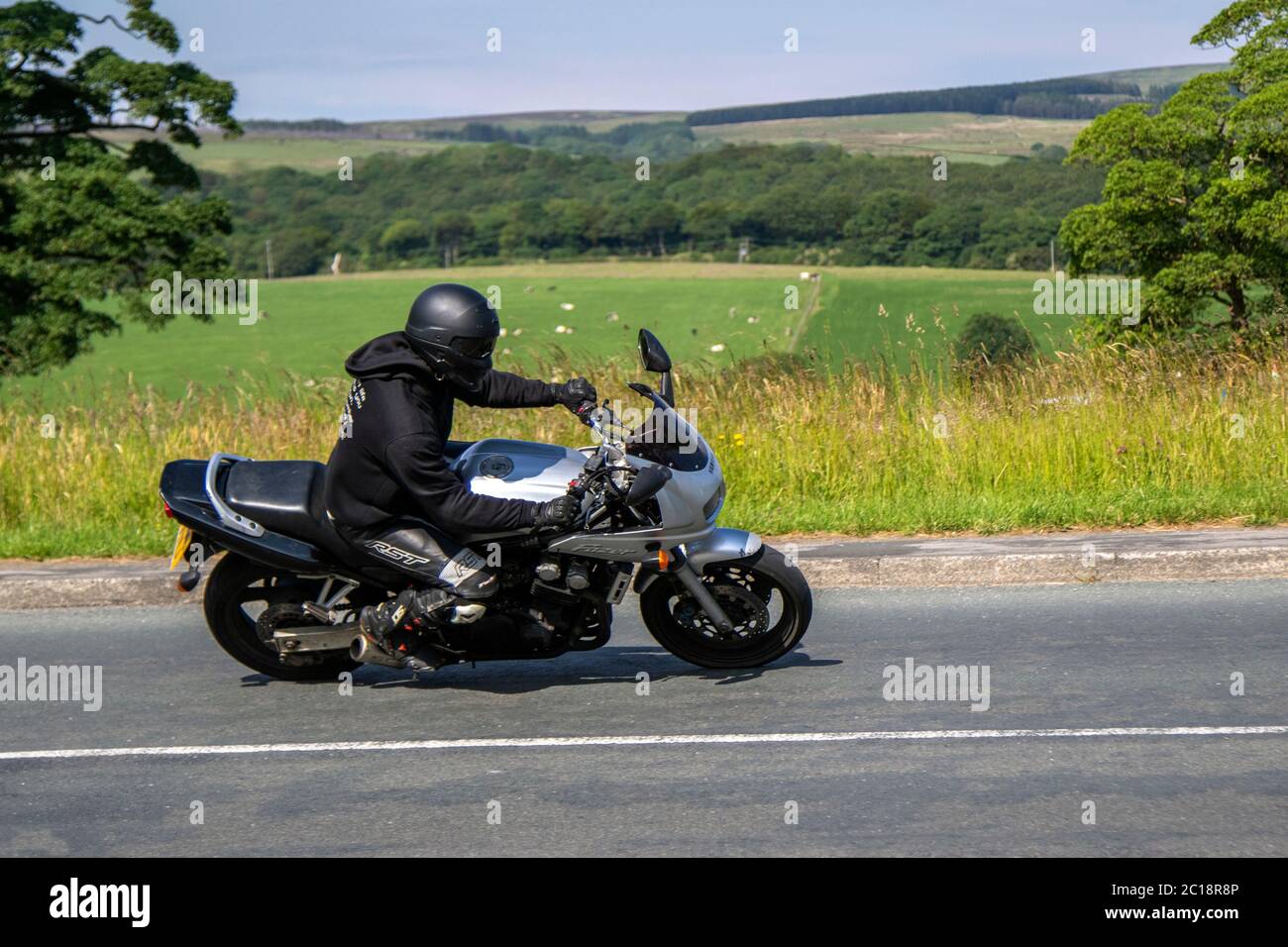 2000 Silver Yamaha Fazer FZS 600; Motorbike rider; two wheeled transport, motorcycles, vehicle, roads, motorbikes, bike riders motoring in Chorley, UK Stock Photo