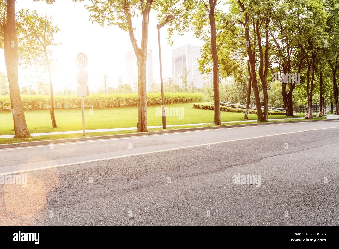 empty asphalt road with green trees Stock Photo - Alamy