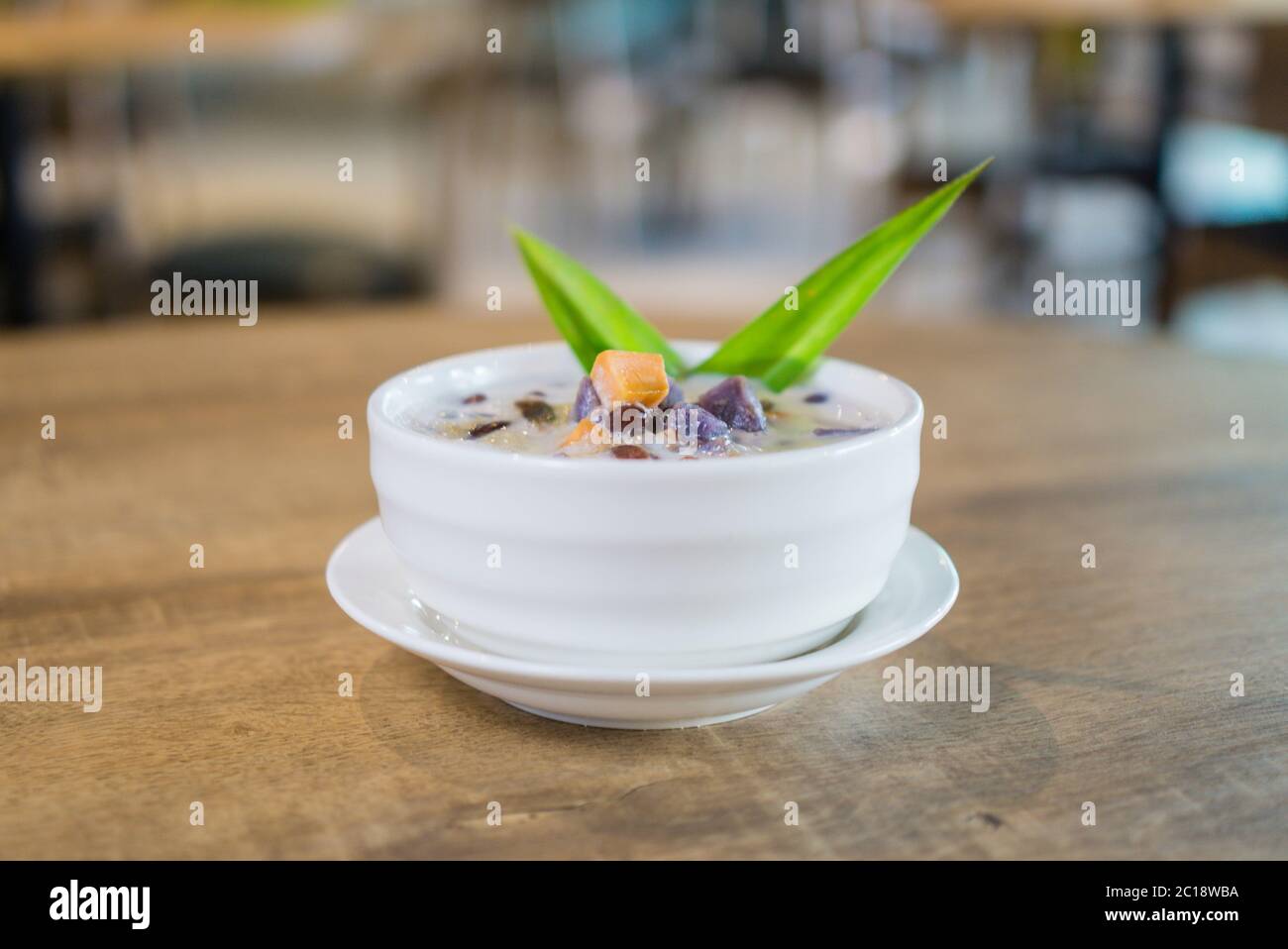 Bubur Cha Cha, Malay dessert made from tapioca pearls, sweet potato, taro and coconut milk. Stock Photo