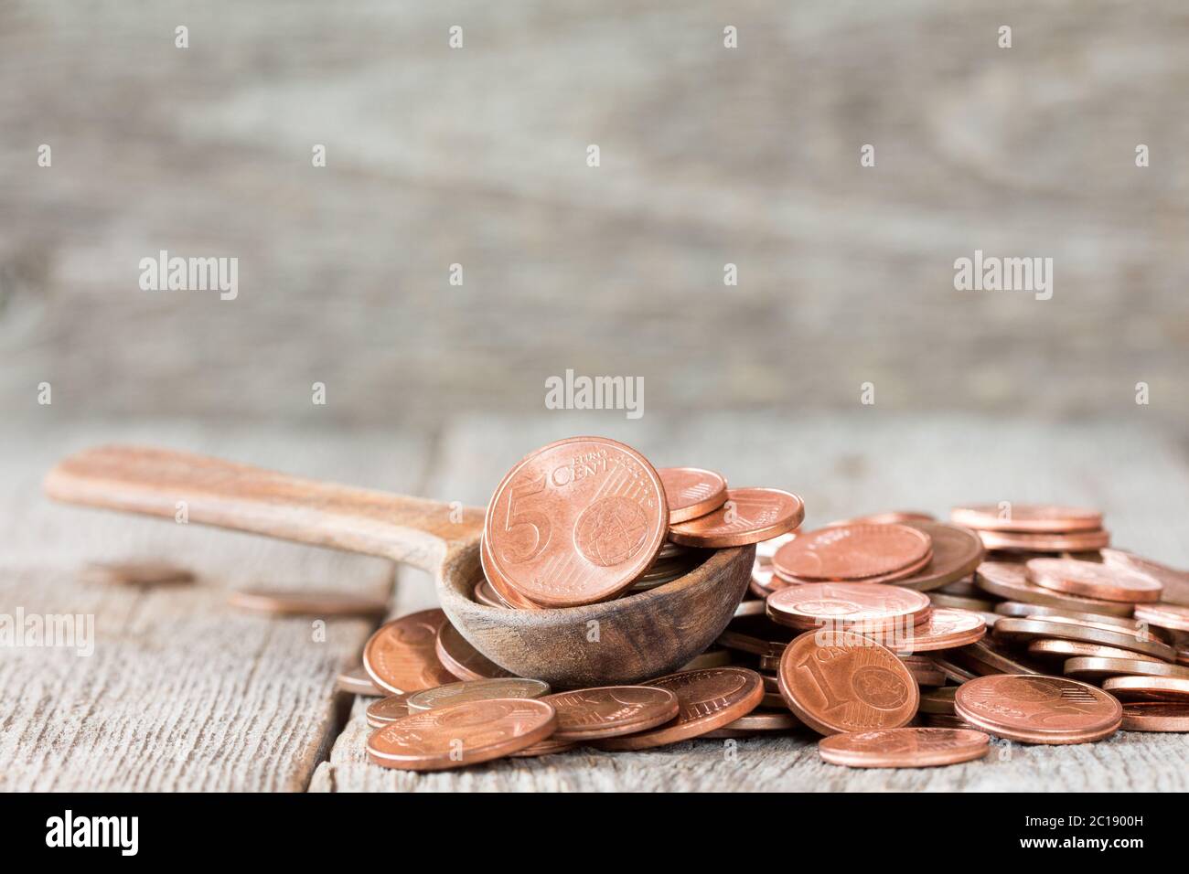 Euro cent coins in wooden spoon Stock Photo
