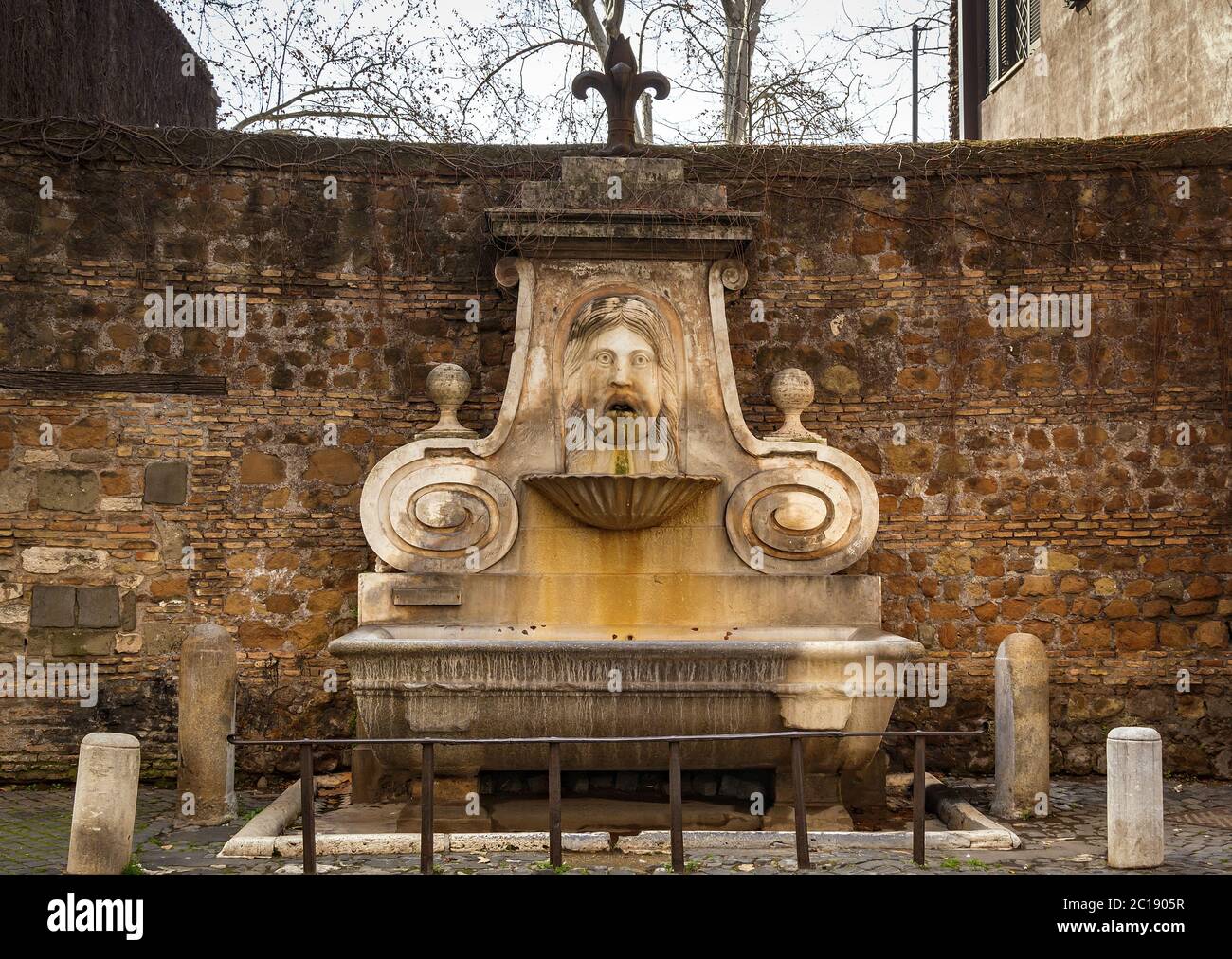 frontal view of the ancient Fountain of the mask (fontana del mascherone) in Rome, Italy Stock Photo