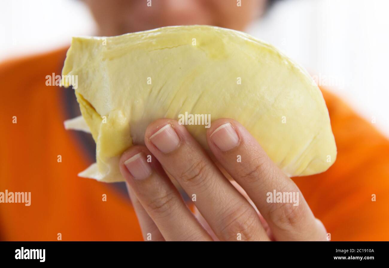Close Up Asian Women Hand Holding Durrian, Durian is the king of fruits. Is a famous fruit in Asia. Stock Photo