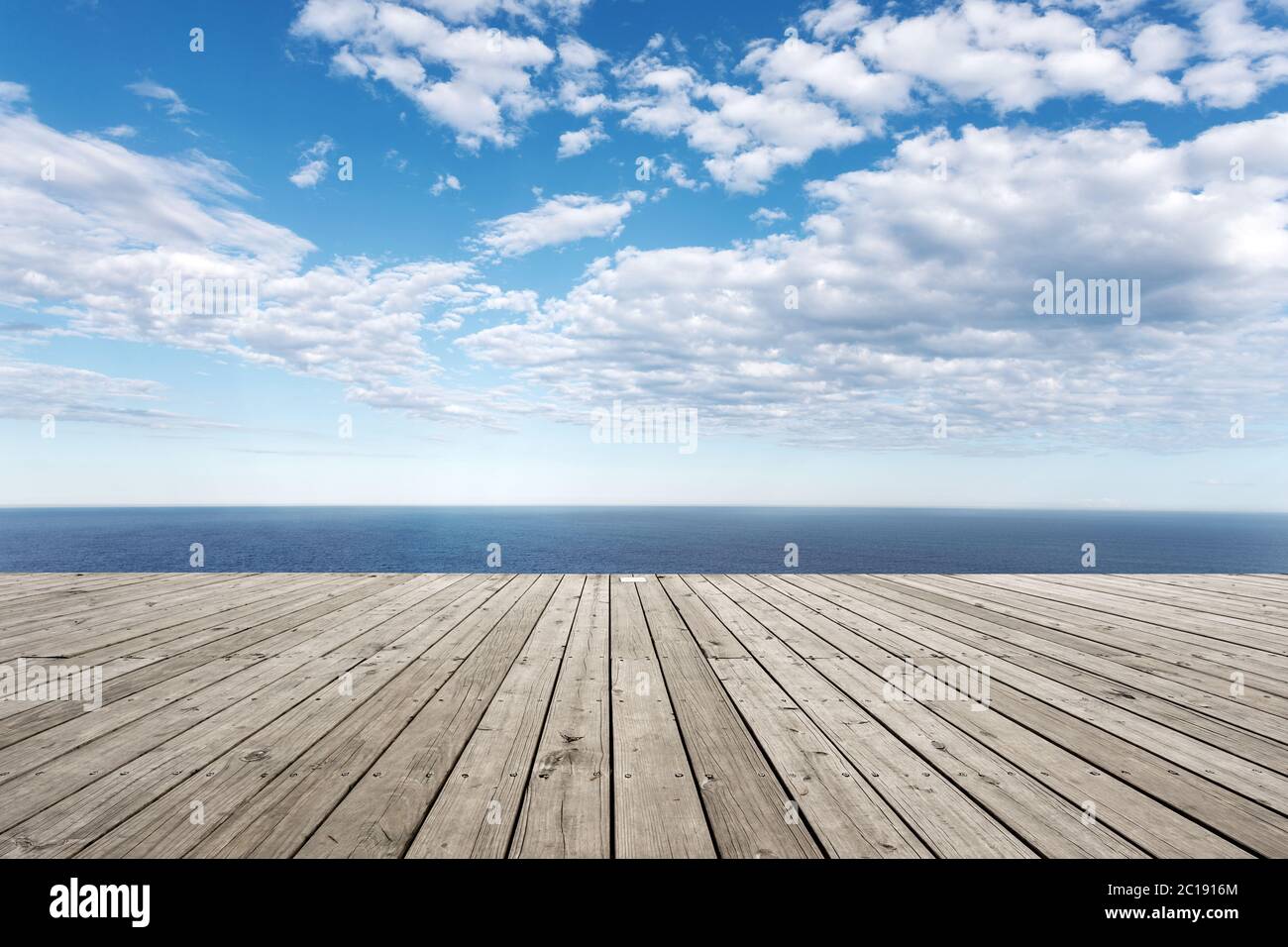 empty wooden floor with beautiful sea in blue cloud sky Stock Photo
