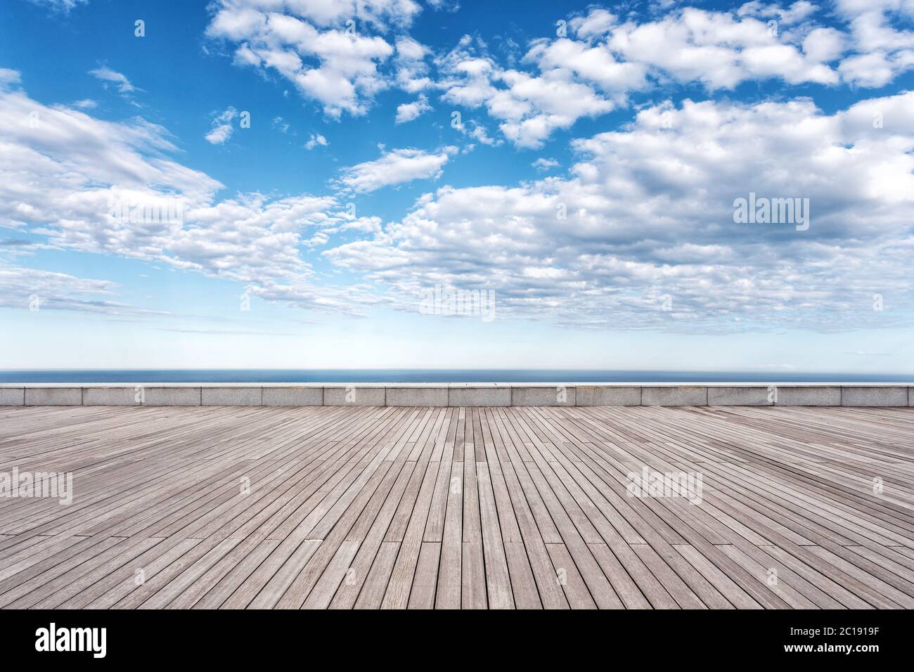 empty wooden floor with beautiful sea in blue cloud sky Stock Photo