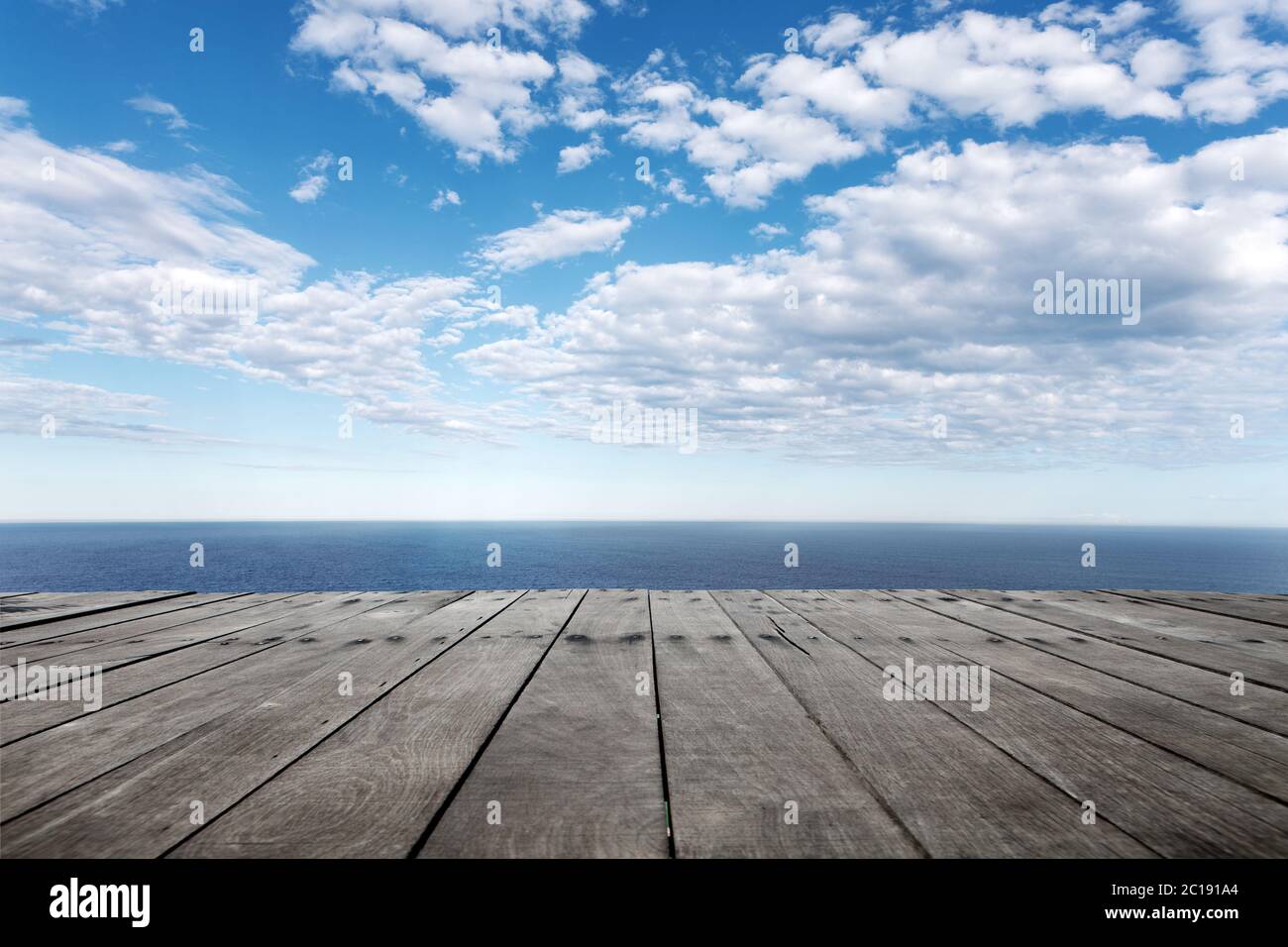 empty wooden floor with beautiful sea in blue cloud sky Stock Photo