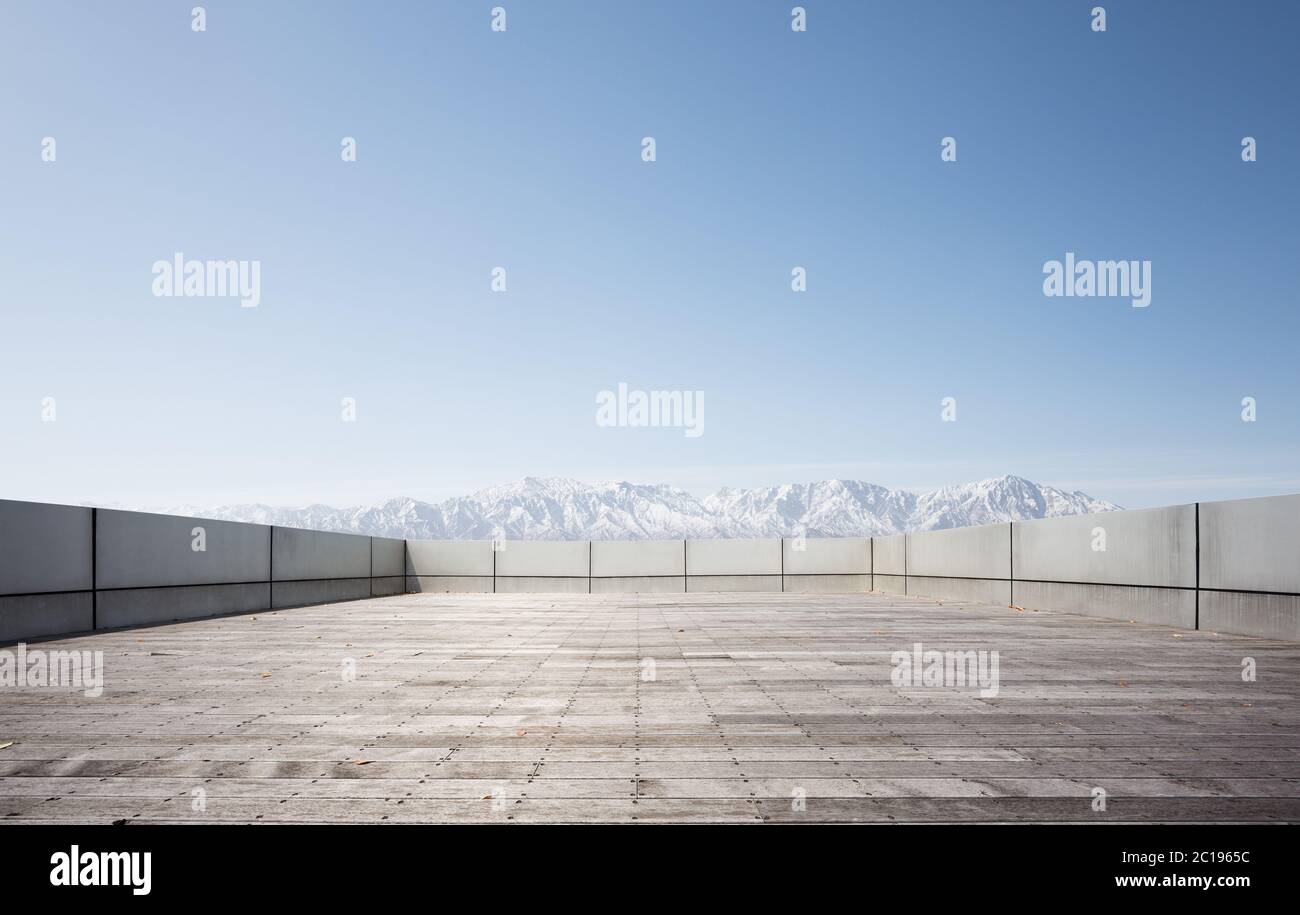 empty brick floor with snow mountains Stock Photo