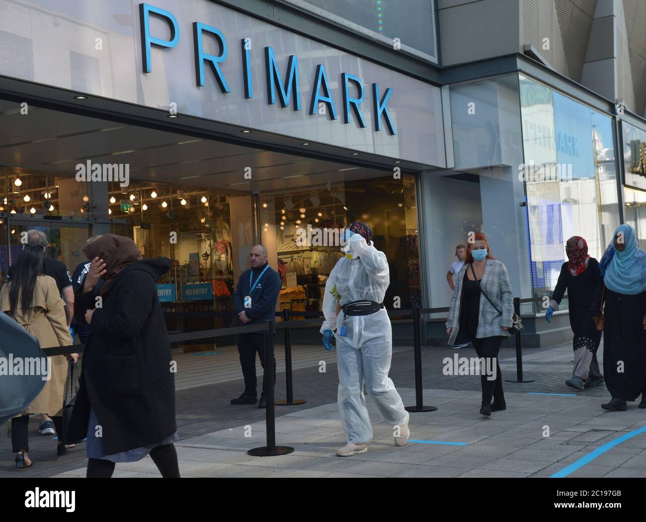 A customer dressed in personal protective equipment (PPE) in line to shop at Primark, Birmingham, as non-essential shops in England open their doors to customers for the first time since coronavirus lockdown restrictions were imposed in March. Stock Photo