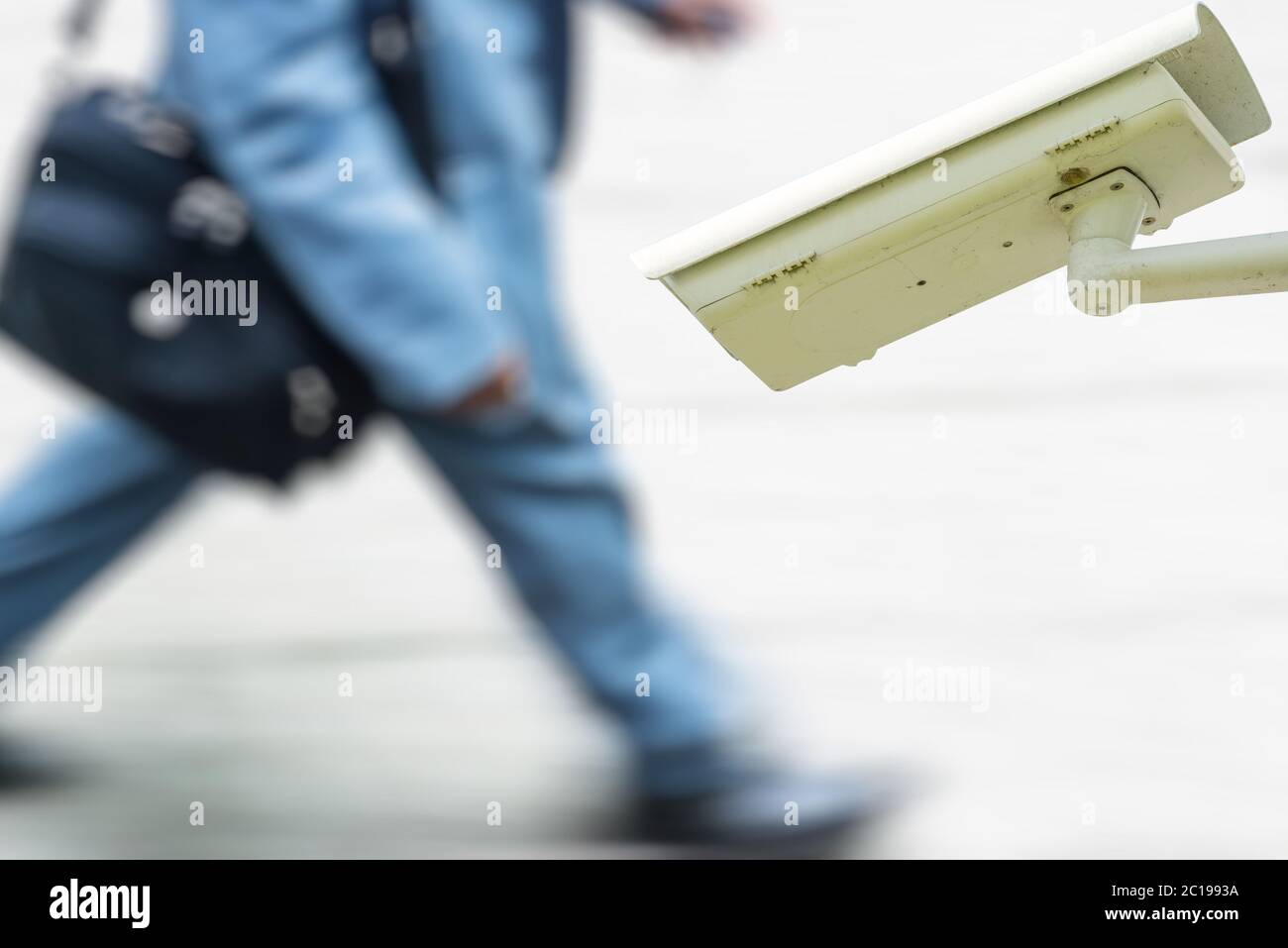 security CCTV camera or surveillance system with business man walking