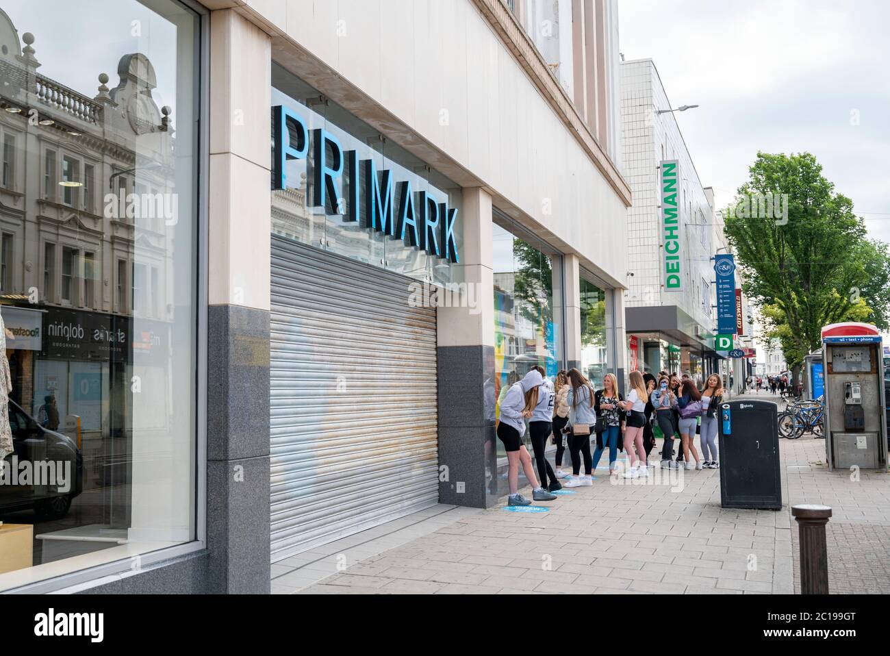 Brighton UK 15th June 2020 - Shoppers queue around the block at the Primark  store in Western