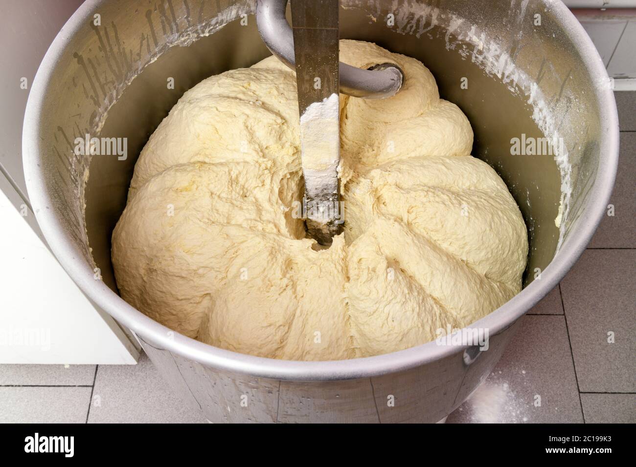 Stainless steel commercial mixing machine with a batch of pizza dough in a  high angle view looking inside during preparation Stock Photo - Alamy