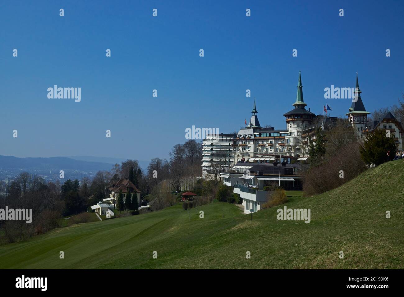 The Dolder Grand Hotel in Zurich Switzerland on a hillside in bright