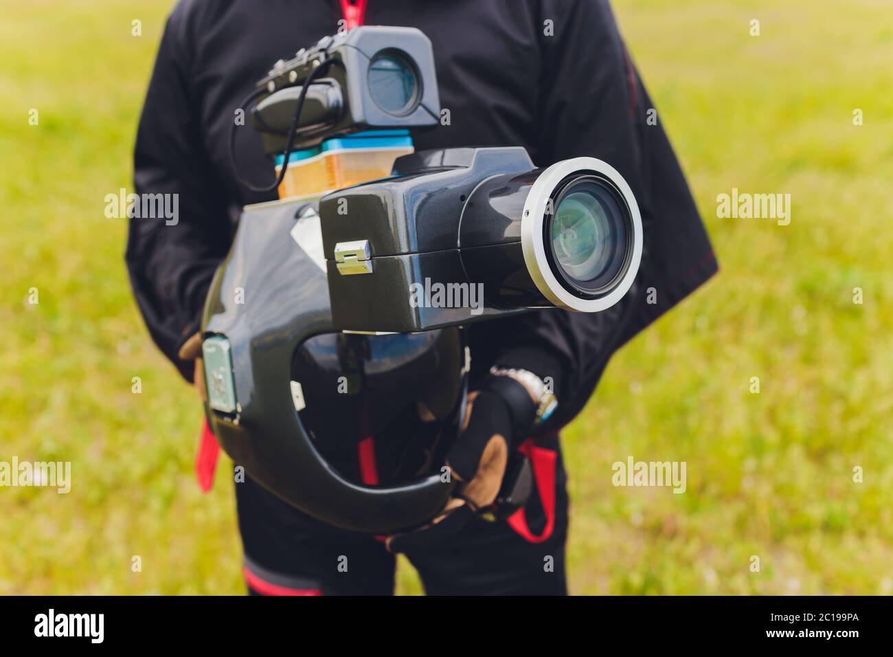 Parachute helmet with an installed DSLR camera in the hands of a