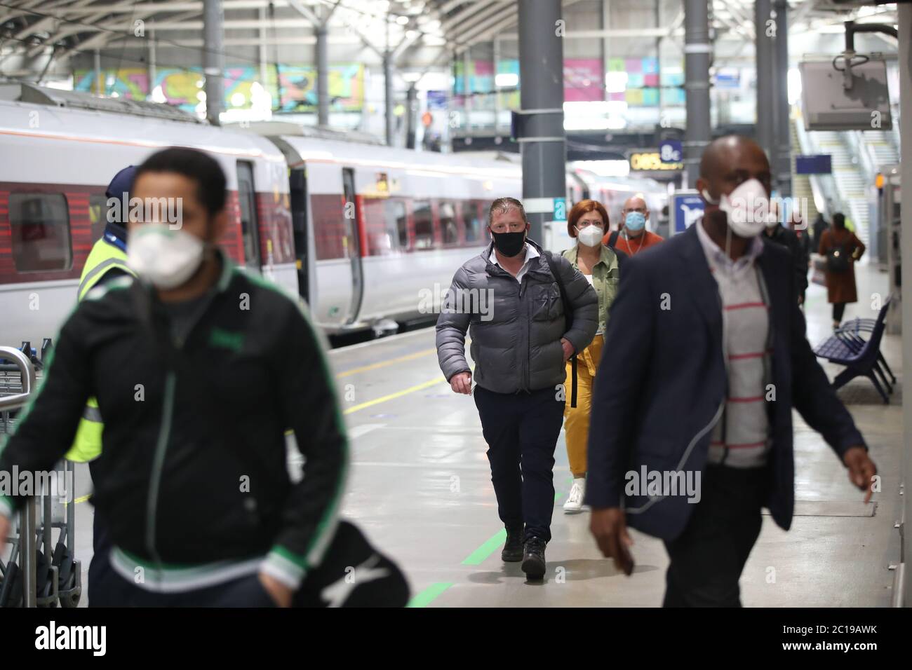 Passengers wearing face masks at Leeds railway station as face coverings become mandatory on public transport in England with the easing of further lockdown restrictions during the coronavirus pandemic. Stock Photo