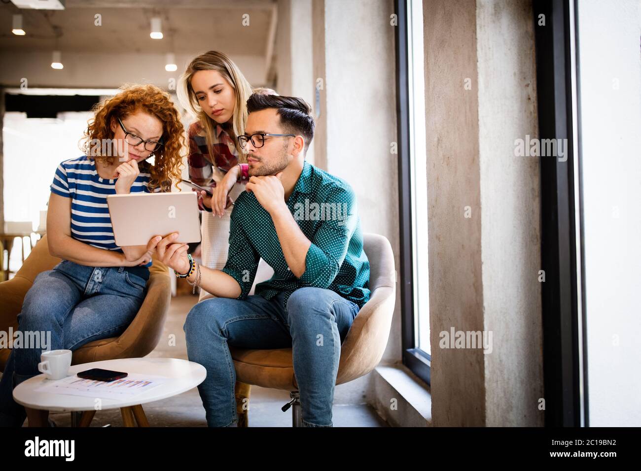 Successful group of designers, business people at work in office Stock Photo